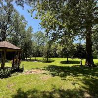 A serene space with a gazebo, perfect for community gatherings that foster mindful stewardship.This tranquil landscape invites people to help preserve its natural beauty and promote community awareness. It is a setting where events can connect people to nature and inspire ahared commitment to the land.