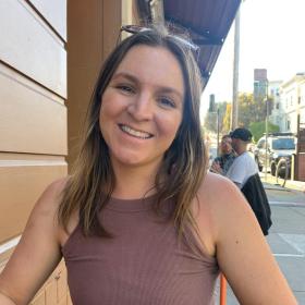 Sara outdoors smiling at camera